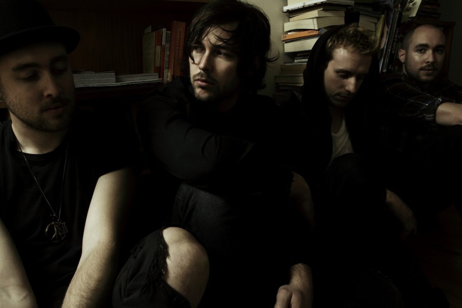The Sun And The Sky — four band members in a low-lit room